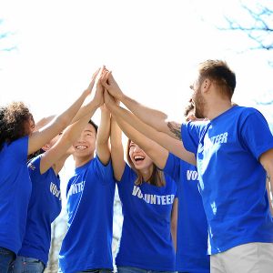 bigstock-group-of-volunteers-in-park-on-184015285